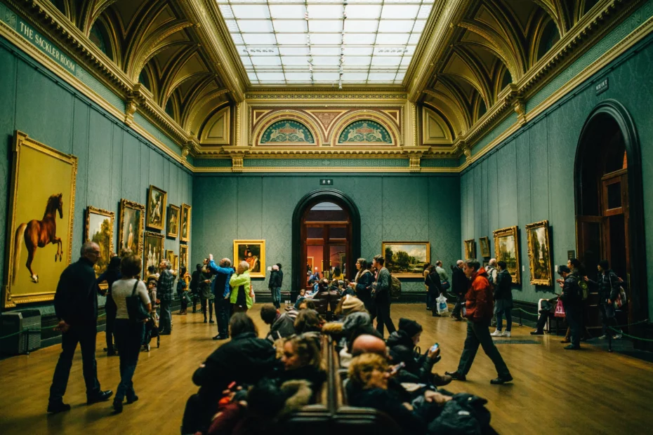 art gallery with people looking at large art work on wall