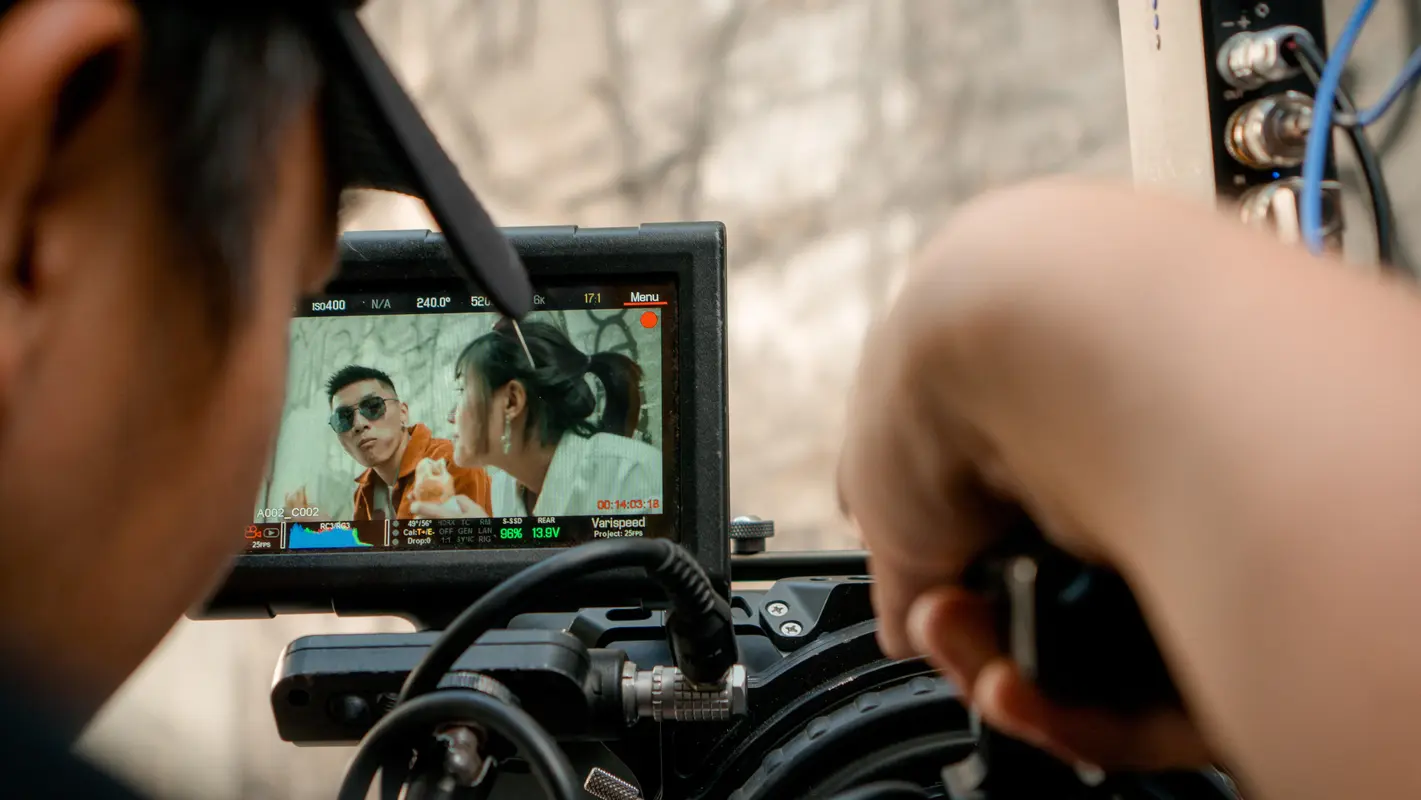 camera operator looking through view finder