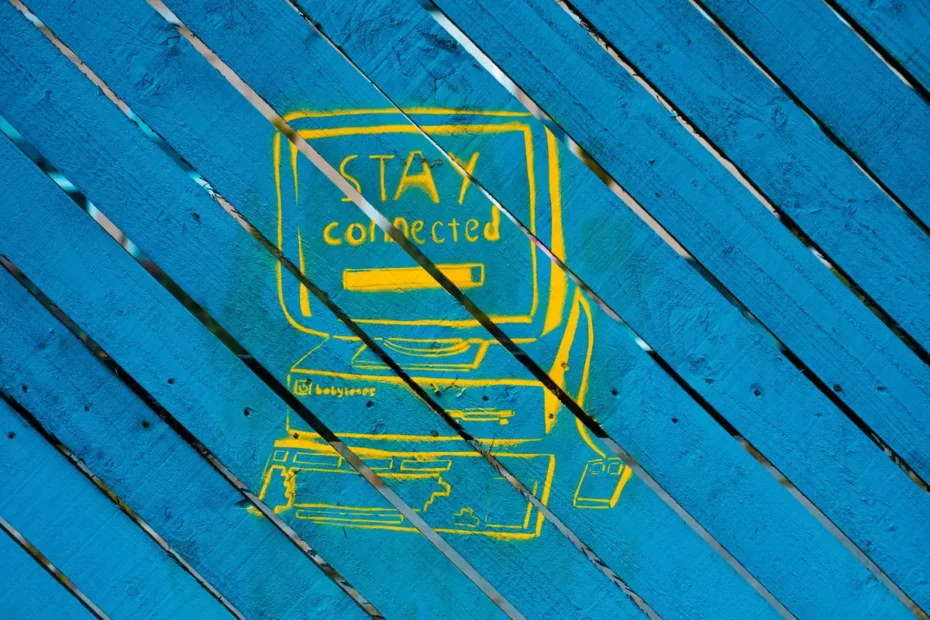 blue wooden fence with computer illustration painted on it