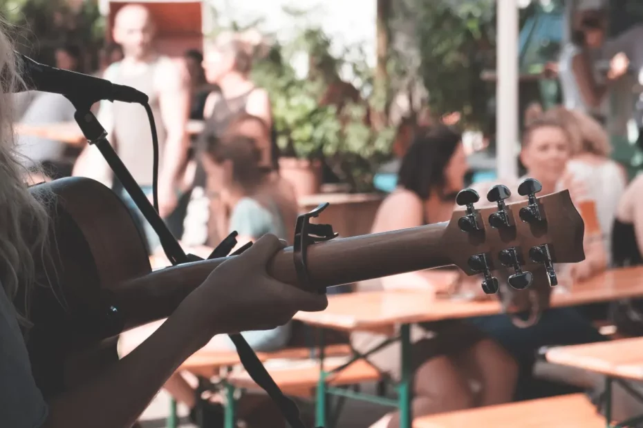 solo singer with guitar in open air restaurant