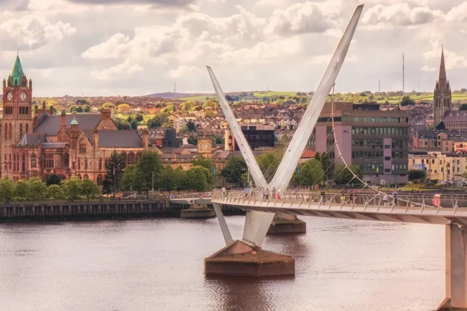 photo of modern walk bridge over river linking to a town on riverside