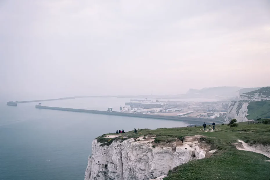 coastal scene with white cliffs harbour and sea