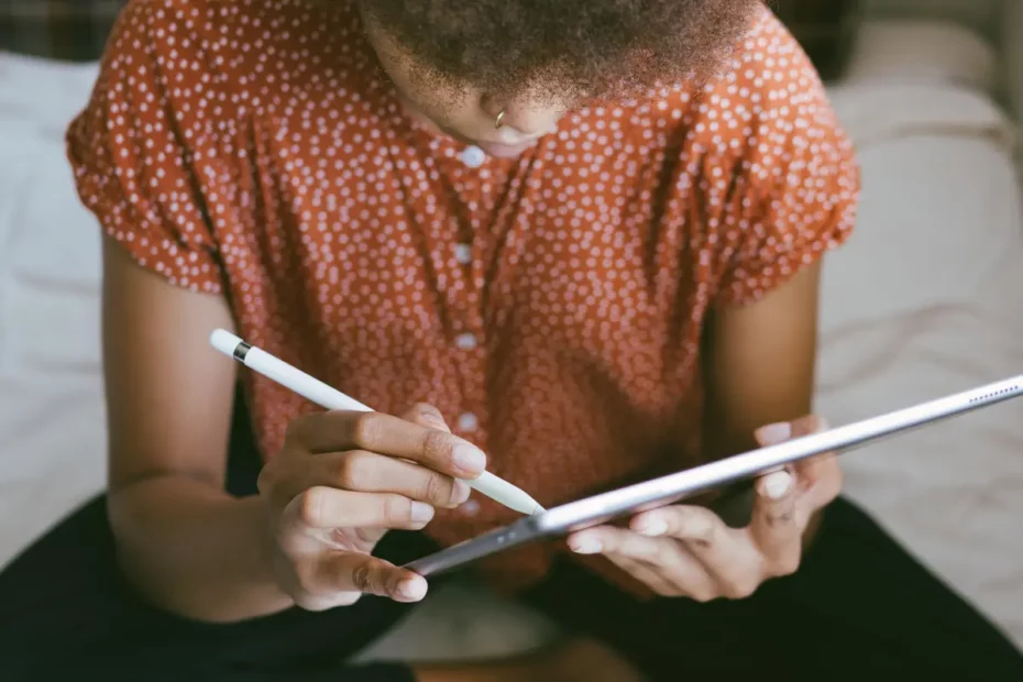 person using stylus on tablet device