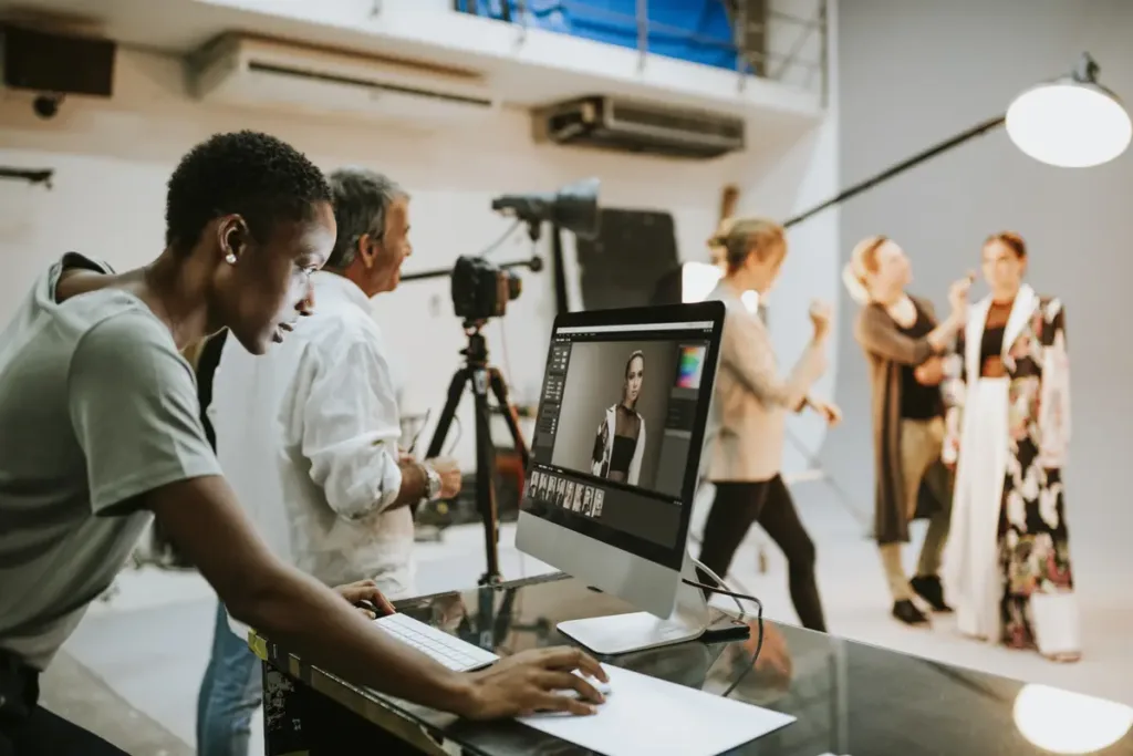 person editing images on computer at photo shoot